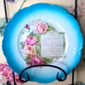 Hand painted calendar advertising plate from 1910. Turquoise & roses